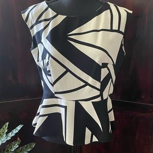 Worthington black & ivory colored abstract peplum top. Zips in back Size M